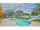 Sparkling screened-in pool and lanai features a fun slide and lush landscaping at 12305 Freesia Ct, Riverview, FL 33569