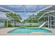 Screened-in pool with slide and mature tropical landscaping at 12305 Freesia Ct, Riverview, FL 33569