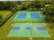Aerial view of tennis and basketball courts with green surroundings at 12305 Freesia Ct, Riverview, FL 33569