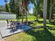 Outdoor seating area in a backyard oasis with lush greenery and tranquil water views in the distance at 2152 Mckinley St, Clearwater, FL 33765