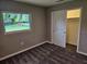 Bright bedroom with plush carpeting, a window with backyard views, and a closet at 2152 Mckinley St, Clearwater, FL 33765