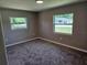 Bedroom with grey carpet, light grey walls, and plenty of natural light from two windows at 2152 Mckinley St, Clearwater, FL 33765
