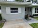 Well-maintained home exterior with decorative shutters, manicured landscaping, and a welcoming entryway at 2152 Mckinley St, Clearwater, FL 33765