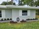 Well-maintained exterior with lush landscaping, a tiled roof, and green grass at 2152 Mckinley St, Clearwater, FL 33765