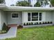 Charming single-story home with well-maintained lawn, lush landscaping, and a tiled roof at 2152 Mckinley St, Clearwater, FL 33765