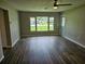 Spacious living room with modern wood floors, large windows providing ample natural light and neighborhood views at 2152 Mckinley St, Clearwater, FL 33765