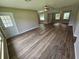 Open-concept living room featuring new wood floors and lots of natural light from large windows at 2152 Mckinley St, Clearwater, FL 33765