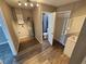 Utility room with vinyl floors, water heater, and access to bathroom at 2152 Mckinley St, Clearwater, FL 33765