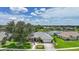 Scenic aerial view of a single-story home on a lush lot with a pond in a suburban neighborhood at 2226 Charleston Park Dr, North Port, FL 34287