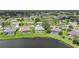 Scenic aerial view of homes with screened-in pools, lush lawns, and water views at 2226 Charleston Park Dr, North Port, FL 34287