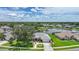 Scenic aerial view of a single-story home on a lush lot with a pond in a suburban neighborhood at 2226 Charleston Park Dr, North Port, FL 34287