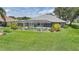 Screened lanai and in-ground pool in a manicured yard, perfect for outdoor living and entertaining at 2226 Charleston Park Dr, North Port, FL 34287