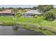 Private backyard with a screened pool area and a picturesque pond offering relaxing water views at 2226 Charleston Park Dr, North Port, FL 34287