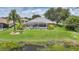 Gorgeous backyard featuring a screened pool, lush landscaping, and a tranquil water view at 2226 Charleston Park Dr, North Port, FL 34287