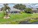 Beautiful backyard featuring a screened pool, lush landscaping, and a serene waterfront view at 2226 Charleston Park Dr, North Port, FL 34287
