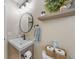 Well-lit bathroom showcasing modern sink, decorative shelf, and neutral decor at 2226 Charleston Park Dr, North Port, FL 34287
