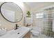 Cozy bathroom with a modern sink, tub-shower combo, and decorative shelving at 2226 Charleston Park Dr, North Port, FL 34287