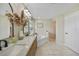Bright bathroom featuring a double vanity with marble countertop, soaking tub, and neutral tile flooring at 2226 Charleston Park Dr, North Port, FL 34287