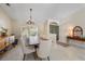 Elegant dining room featuring a chandelier, table set for eight, and a large front window at 2226 Charleston Park Dr, North Port, FL 34287
