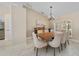 Bright dining area with a wood table, seating for six, and natural light from a window with shutters at 2226 Charleston Park Dr, North Port, FL 34287