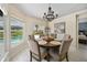 Cozy dining room featuring a chandelier and views of the inviting pool area at 2226 Charleston Park Dr, North Port, FL 34287