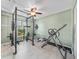 Home gym featuring weightlifting equipment, ceiling fan, and window for natural light at 2226 Charleston Park Dr, North Port, FL 34287