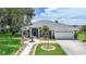 Well-kept single-story home featuring a landscaped walkway, lush lawn, and a two-car garage at 2226 Charleston Park Dr, North Port, FL 34287