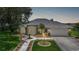 Charming single-story home featuring a landscaped walkway, lush lawn, and a two-car garage at 2226 Charleston Park Dr, North Port, FL 34287