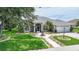 Well-kept single-story home featuring a landscaped walkway, lush lawn, and a two-car garage at 2226 Charleston Park Dr, North Port, FL 34287