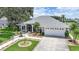 Charming single-story home with a manicured lawn, landscaped walkway, and a two-car garage at 2226 Charleston Park Dr, North Port, FL 34287
