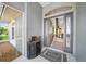 Inviting foyer with a welcome mat, decorative cabinet, and view into the open-concept living spaces at 2226 Charleston Park Dr, North Port, FL 34287