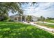 Beautiful single-story home featuring lush green lawn, mature trees, and well-maintained landscaping at 2226 Charleston Park Dr, North Port, FL 34287