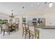 Modern kitchen with white cabinetry, stainless steel appliances, bar seating, and dining area at 2226 Charleston Park Dr, North Port, FL 34287