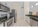 Modern kitchen with stainless steel appliances, white cabinets, and a breakfast bar at 2226 Charleston Park Dr, North Port, FL 34287