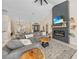 Open-concept living room featuring a fireplace, television, and views of the dining area and front entrance at 2226 Charleston Park Dr, North Port, FL 34287