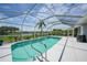 Sparkling screened pool with clear blue water, surrounded by a spacious deck and tropical foliage at 2226 Charleston Park Dr, North Port, FL 34287