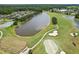 Beautiful aerial view showcasing golf course with sand traps, pond, and walking paths at 23346 Abercorn Ln, Land O Lakes, FL 34639