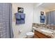 Cozy bathroom featuring granite countertops, and blue towels with shower at 23346 Abercorn Ln, Land O Lakes, FL 34639
