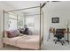 Bedroom featuring a four poster bed frame, ceiling fan and two work stations at 23346 Abercorn Ln, Land O Lakes, FL 34639