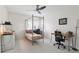 Bedroom featuring a four poster bed frame, ceiling fan and two work stations at 23346 Abercorn Ln, Land O Lakes, FL 34639