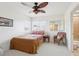 Comfortable bedroom features ceiling fan, wicker chair and plenty of natural light at 23346 Abercorn Ln, Land O Lakes, FL 34639