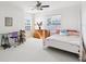 Bright bedroom offering a desk, a dresser and a white poster bed at 23346 Abercorn Ln, Land O Lakes, FL 34639