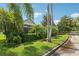 Exterior view of the home from the street highlighting the tropical landscaping at 23346 Abercorn Ln, Land O Lakes, FL 34639