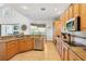 Bright kitchen with granite countertops, stainless steel appliances, and a view of the pool area at 23346 Abercorn Ln, Land O Lakes, FL 34639