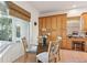 Kitchen eat-in area with a view of the pool through the window, features a built-in desk and ample cabinet space at 23346 Abercorn Ln, Land O Lakes, FL 34639