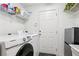 Functional laundry room featuring a Samsung washing machine and utility sink at 23346 Abercorn Ln, Land O Lakes, FL 34639