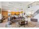 Open-concept living space with views of the kitchen, staircase, and comfortable furnishings at 23346 Abercorn Ln, Land O Lakes, FL 34639
