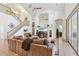 Comfortable living room with an open floor plan, staircase, and a mirrored entertainment center at 23346 Abercorn Ln, Land O Lakes, FL 34639