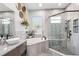 Modern main bathroom with a separate shower, soaking tub, and double vanity at 23346 Abercorn Ln, Land O Lakes, FL 34639
