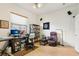 Bright office features neutral tones, a desk, chair, and a dark bookshelf at 23346 Abercorn Ln, Land O Lakes, FL 34639